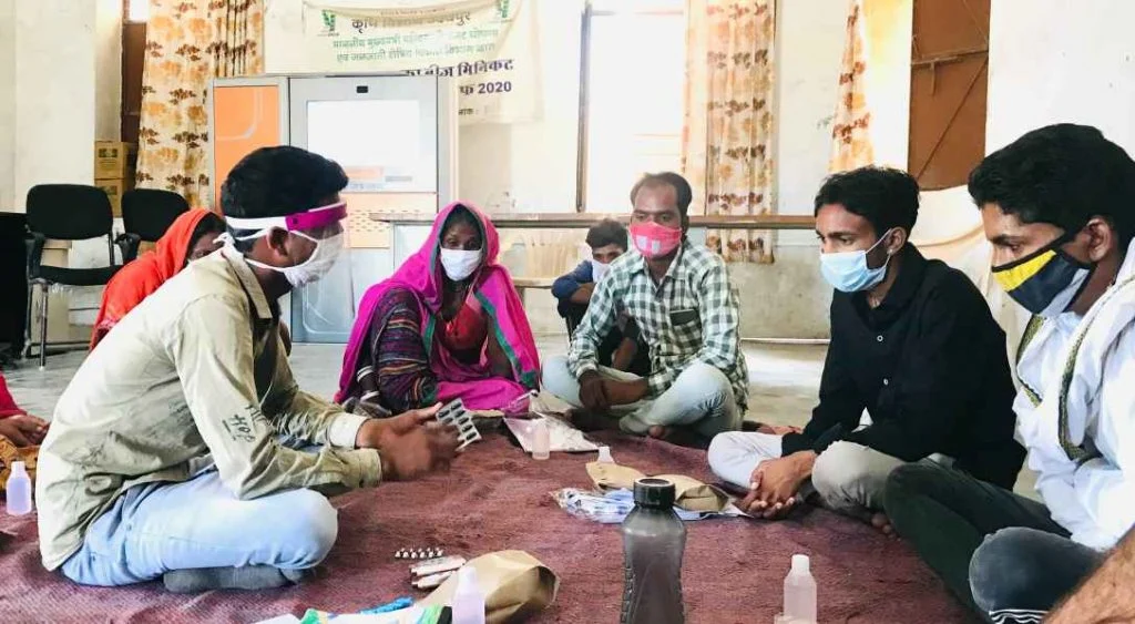 Volunteers gathered around in a circle wearing masks attending training-Picture courtesy: Basic Health Services-vaccine hesitancy-rural Rajasthan