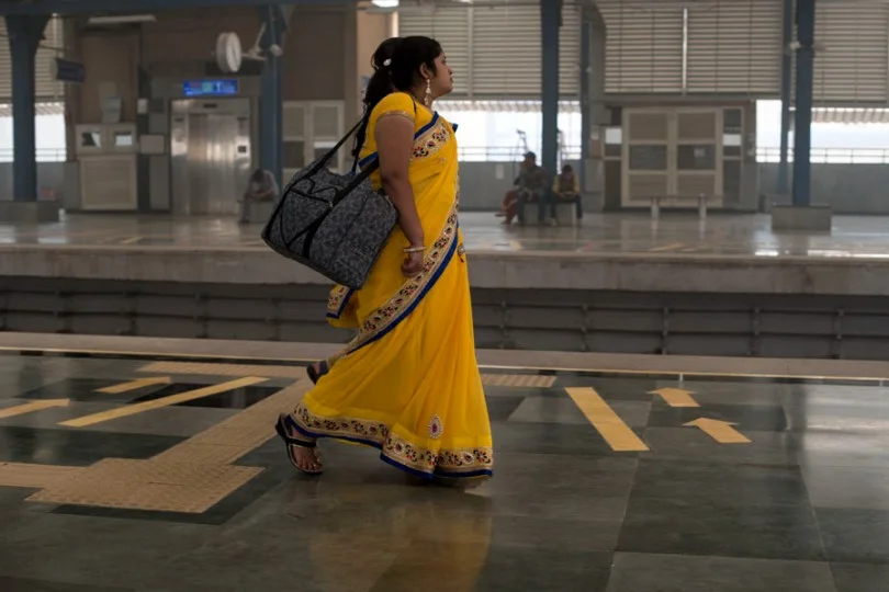 Woman walking on the platform at delhi metro-urban employment scheme-picture courtesy: Flickr