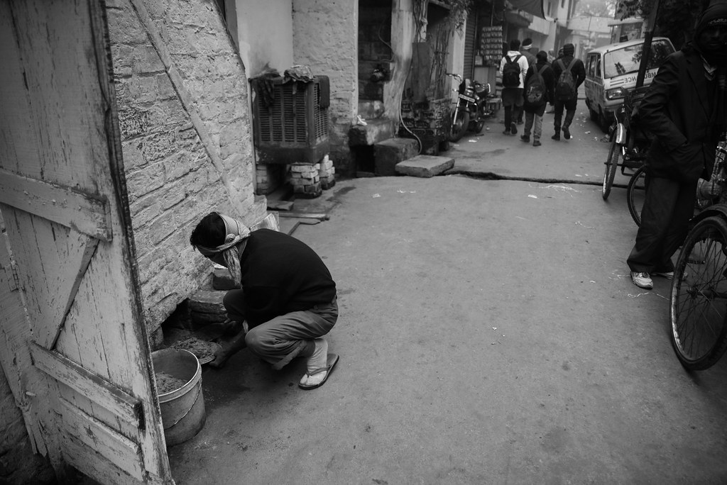 A sanitation worker cleaning the drain