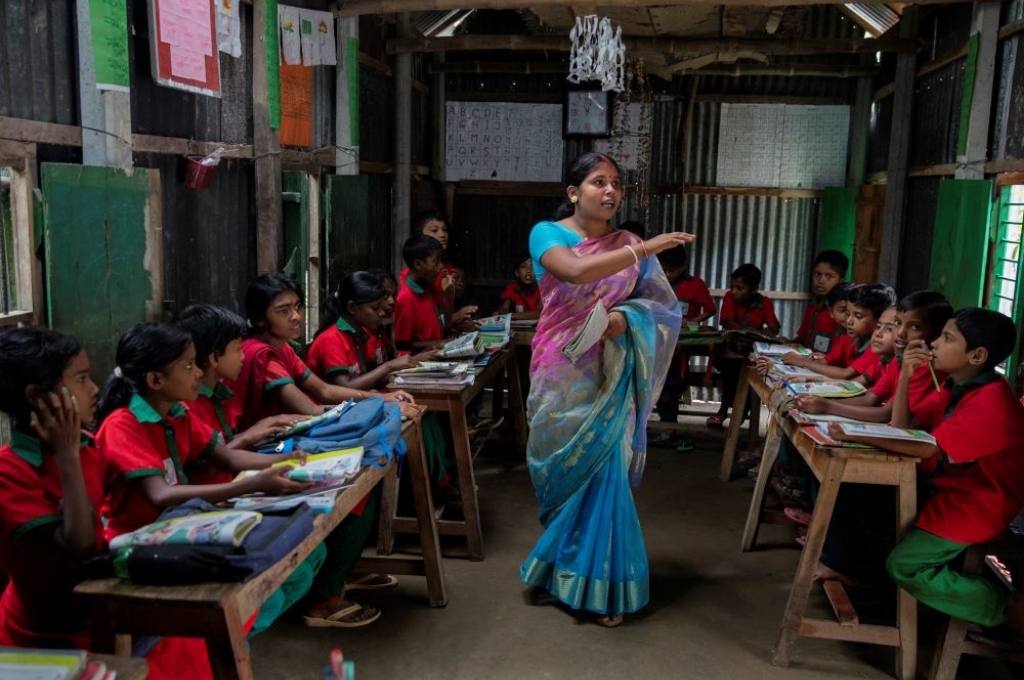 students listen to their teacher-