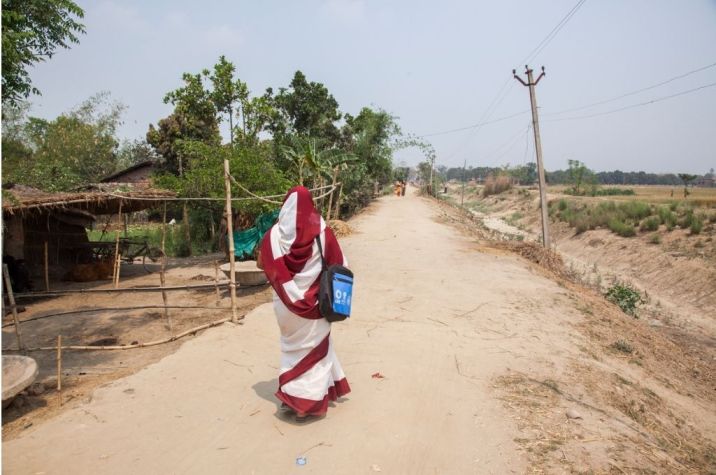 An ASHA worker walking on an empty road_Bill & Melinda Gates Foundation_Prashant Panjiar-ASHA worker