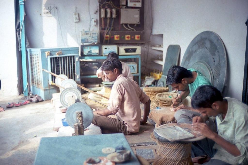 a group of craftsman working on machines-employment