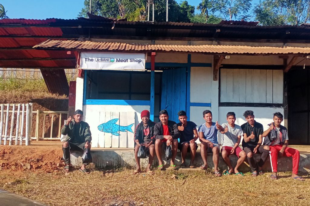 Seven boys sitting outside a fish shop in Meghalaya_Anant Innovation-aquaculture Meghalaya
