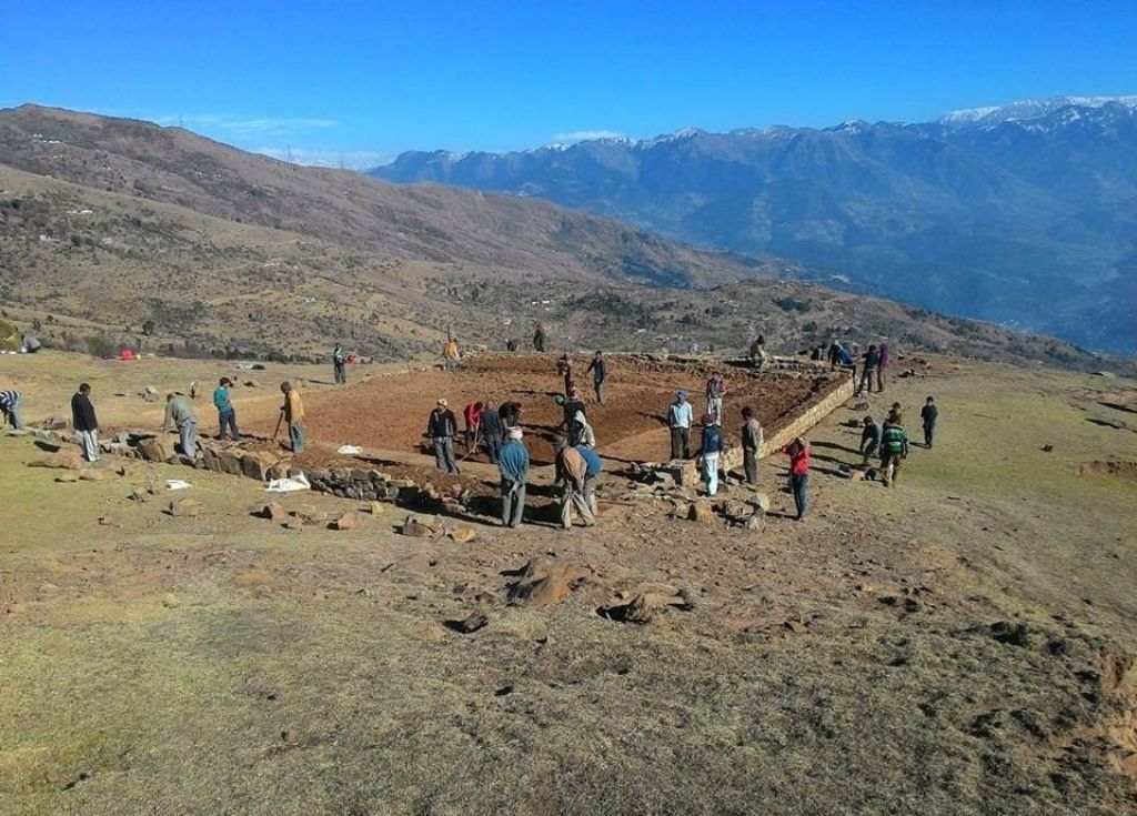 A bunch of people with equipment in a mountainous area of Kashmir building a wrestling stadium. How building a wrestling stadium in Jammu and Kashmir challenged the mindset of a development professional