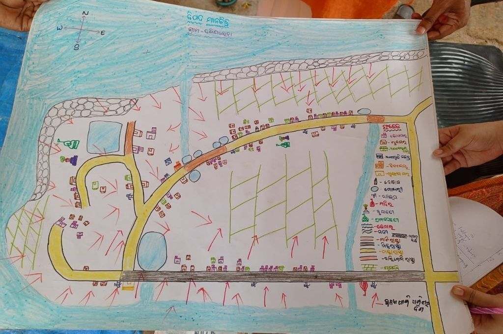 A hand-drawn risk map on a sheet of paper. Map-making is an art that helps people during cyclone and flood in Odisha