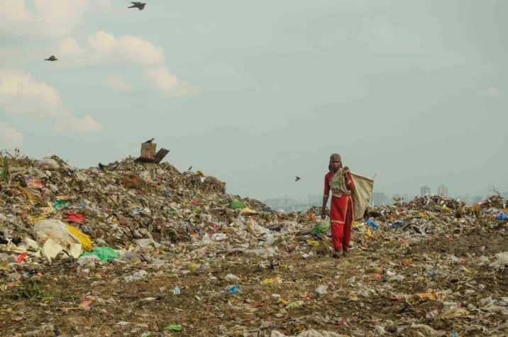 A ragpicker making her way through garbage at the Ghazipur landfill near New Delhi-waste management