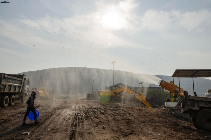 Sprinklers at the Ghazipur landfill near New Delhi spray water droplets into the air to combat suspended dust-waste management