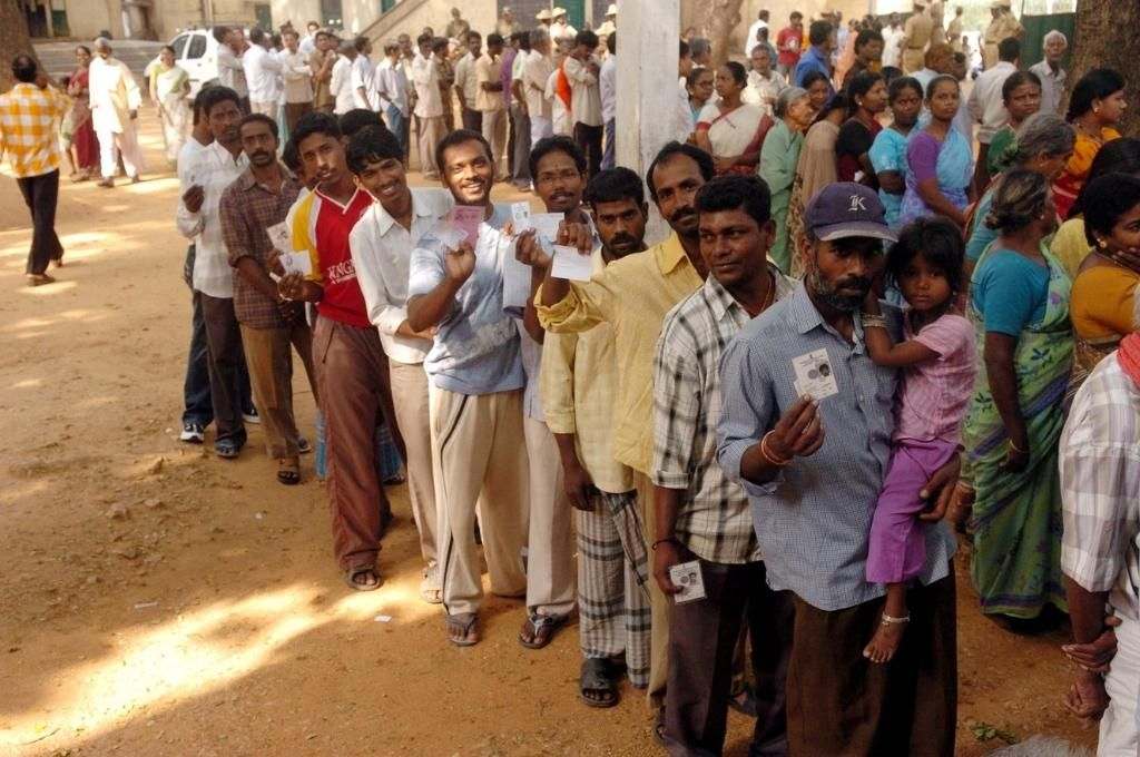 A long queue of male and female voters at a polling booth-social welfare