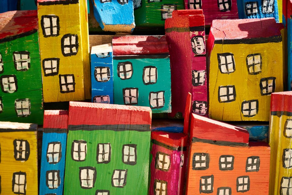 colourful blocks painted as buildings with windows - wealth tax
