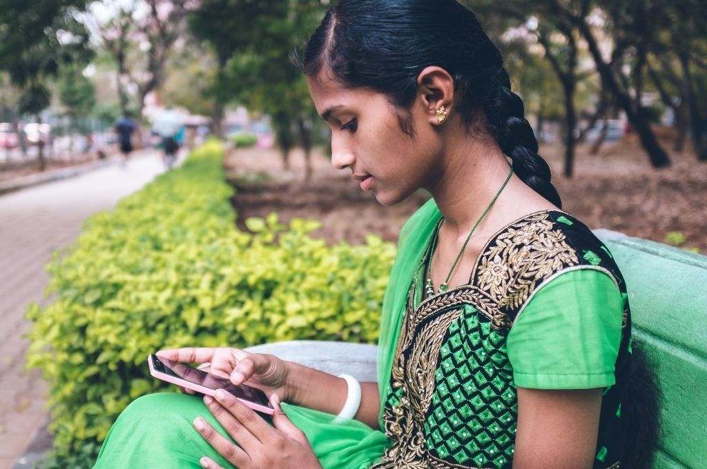 A young mentee on her phone_Credit_Mentor Together. In India young women’s ability to participate in the workforce is constrained by many factors, including a skills deficit and restrictive gender norms. Here’s how digital mentoring can unlock their potential.