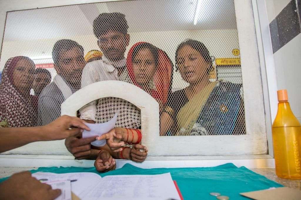 Workers standing at the other side of a counter_e-shram