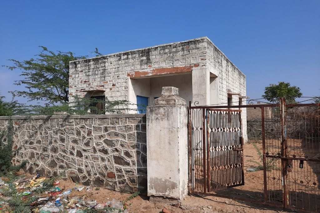 An abandoned healthcare centre with an open gate_girls' education