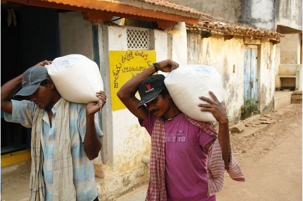 two men carrying sacks - ration card