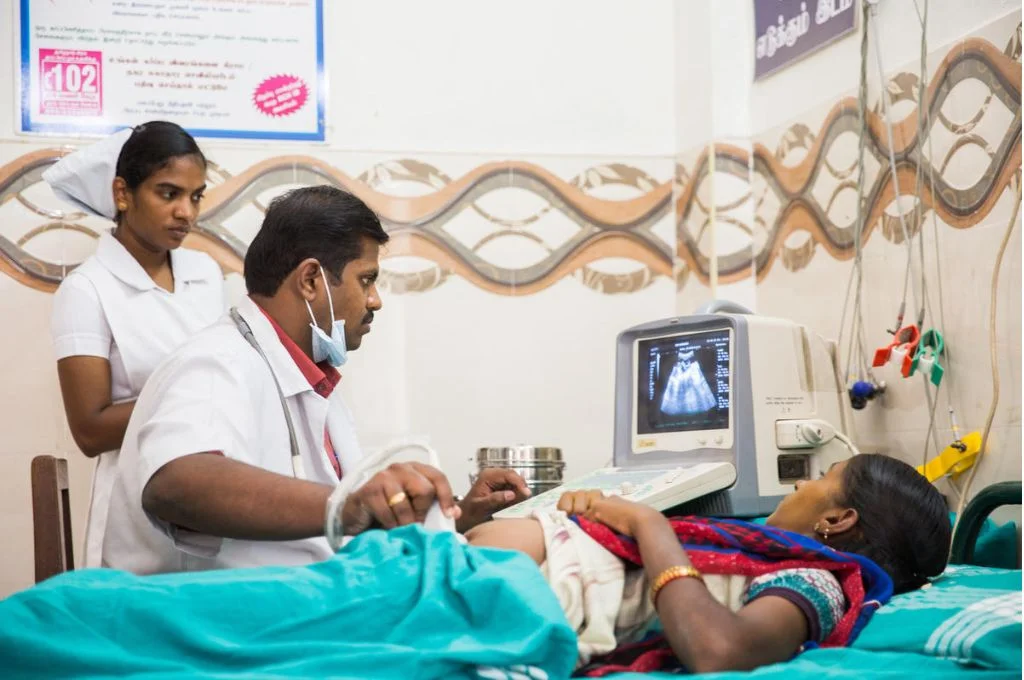 Doctor examining a pregnant woman's ultrasound as a nurse looks on_Gates Archive-abortion