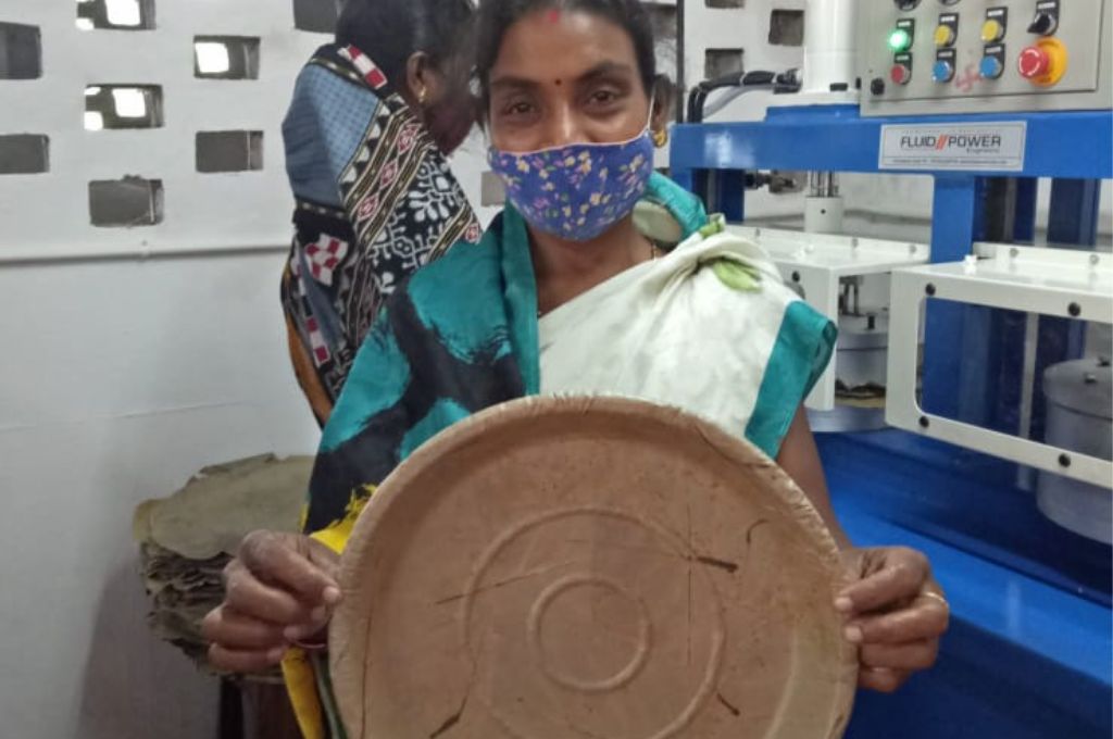Rina Sethi holds up a leaf plate in the manufacturing unit