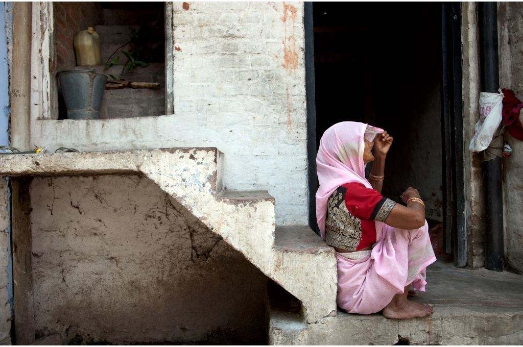A sari-clad woman sitting outside her home_Flickr-census