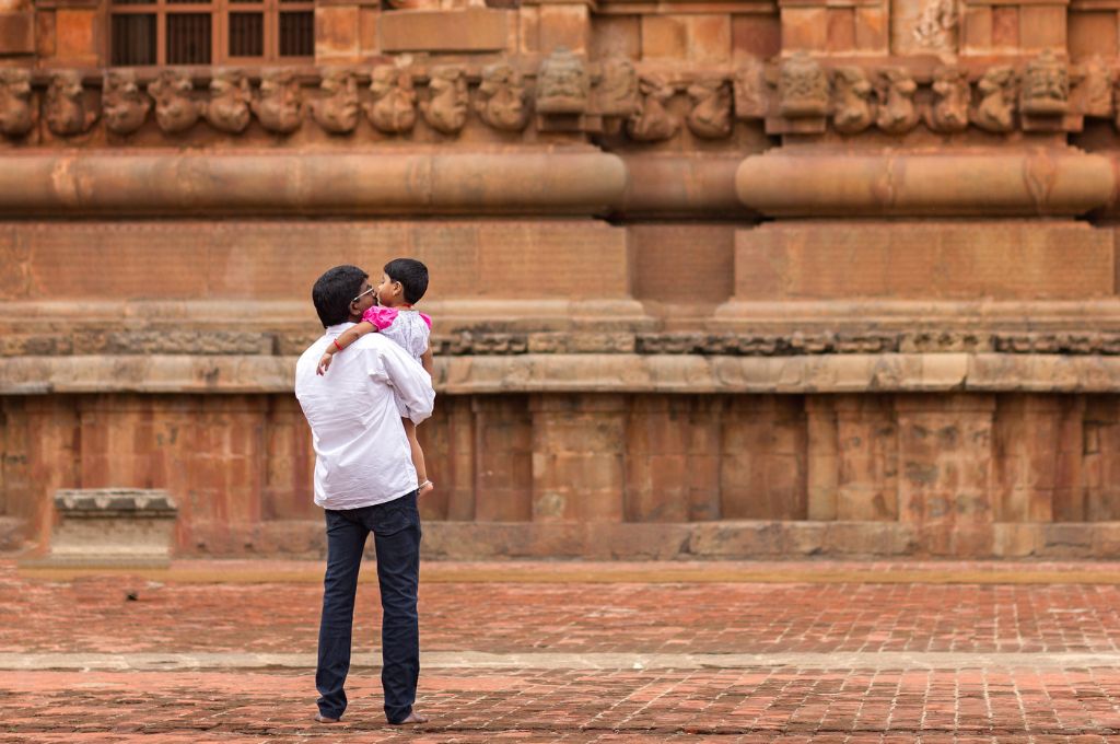 picture of a man carrying his young daughter at a heritage site