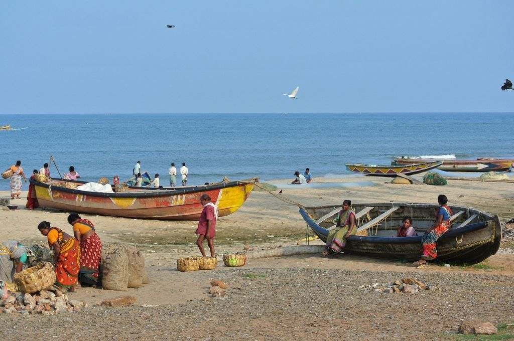 Fisherwomen with boats by a river in India_life below water_lifebelow water