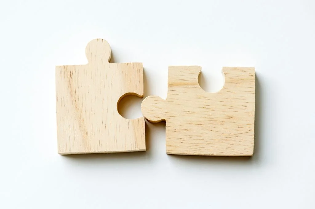 Two pieces of jigsaw puzzle coming together_individual giving