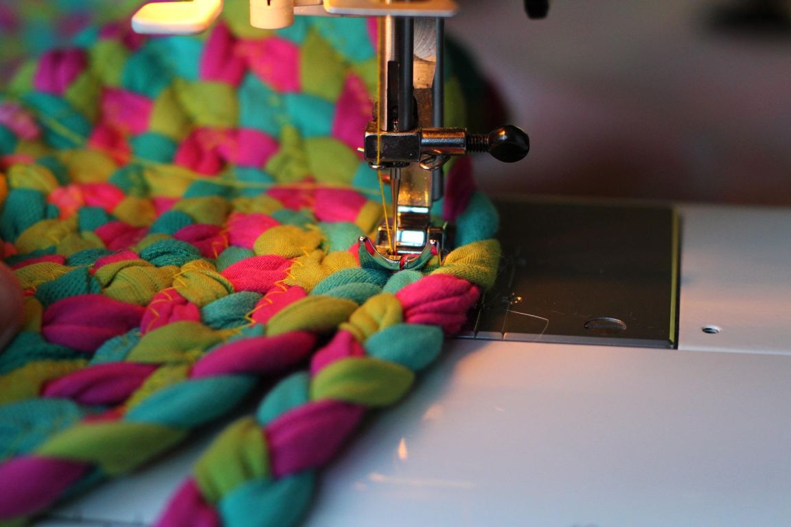 close up of a sewing machine stitching colourful cloth together-nonprofit