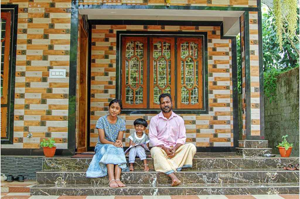Jayachandran and his daughters sit in front of their new home in Kerala’s Idukki district-climate