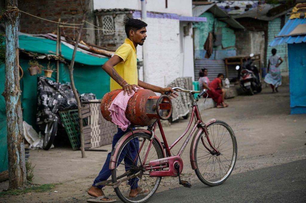 A man carrying an LPG cylinder on a cycle_air pollution