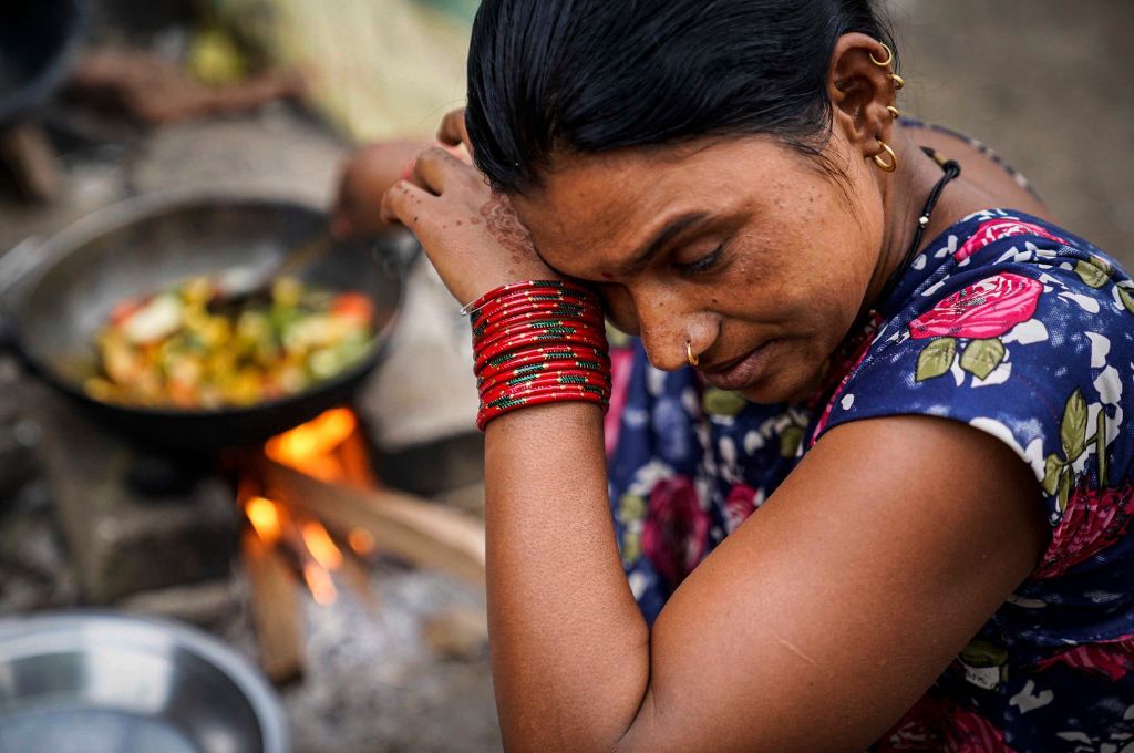 A woman with bangles on her hand rubbing her eye_air pollution