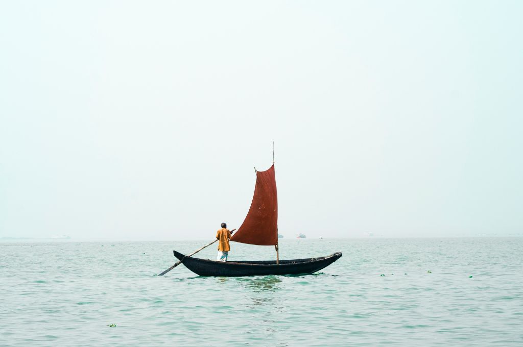 A man standing on a boat in the sea-leadership