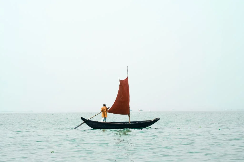 A man standing on a boat in the sea-leadership
