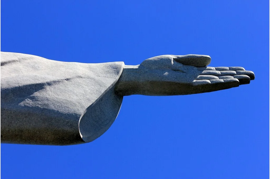 Close up of the outstretched arm of the Christ the Redeemer statue in Rio-generosity