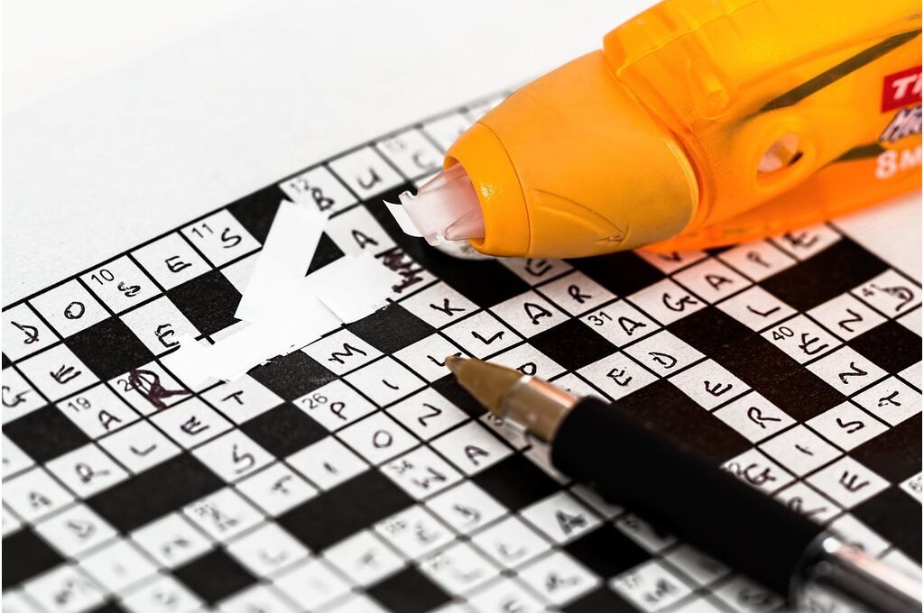 Image depicting white ink being used on a crossword answer