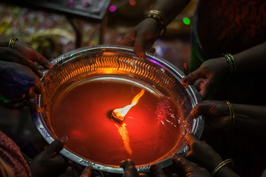 close up of an aarti plate with women's hands holding it-women's health