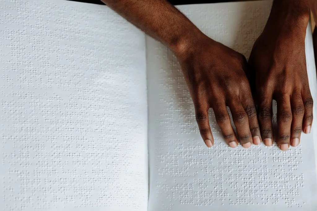 Hands on a braille book_disability