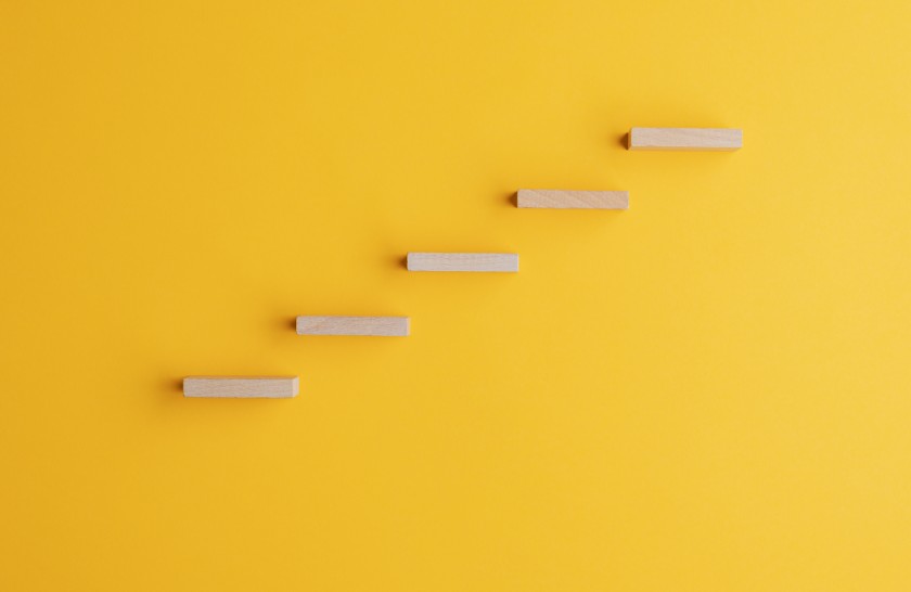 Wooden steps against yellow background-fundraising