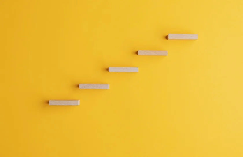 Wooden steps against yellow background-fundraising