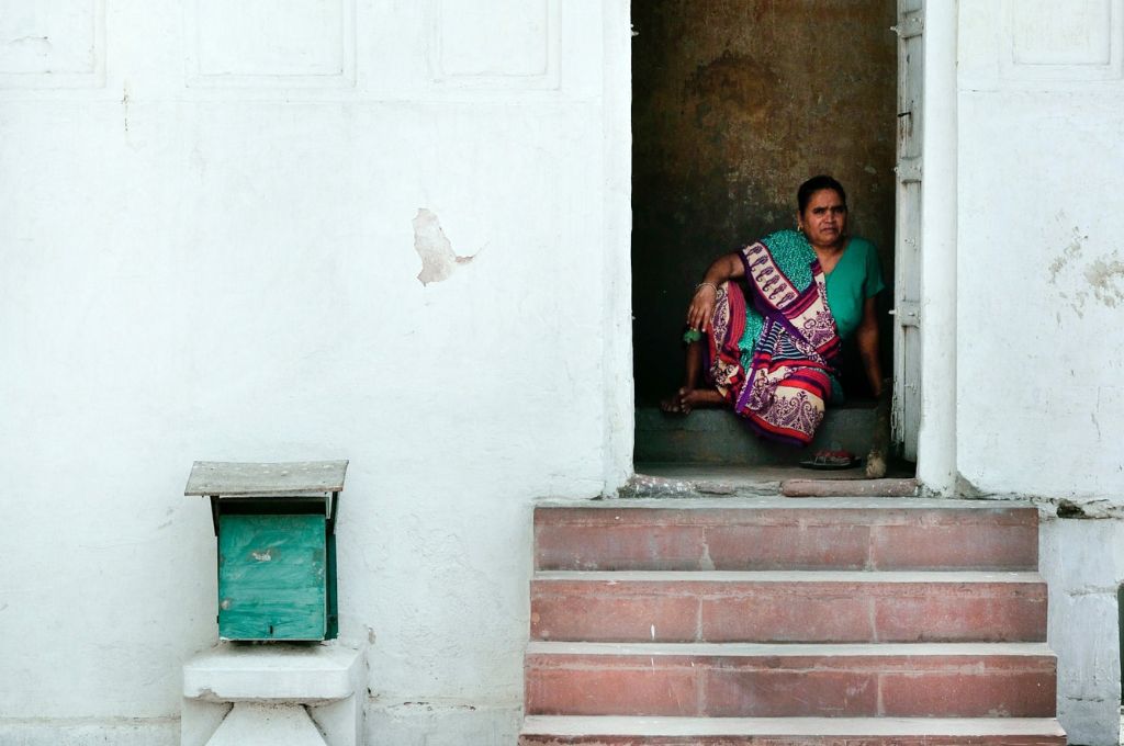 A woman sitting in a room with doors open_mental healthcare in India fails marginalised people
