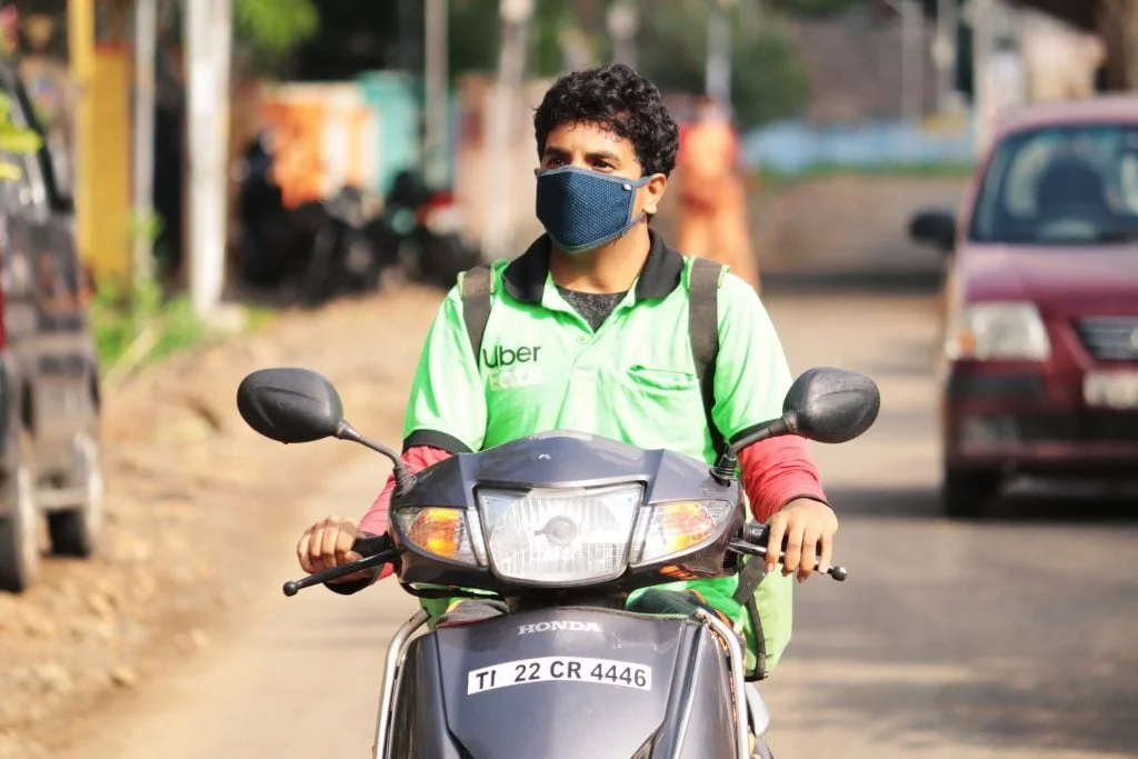Close up of uber eats delivery boy on scooter_gig economy