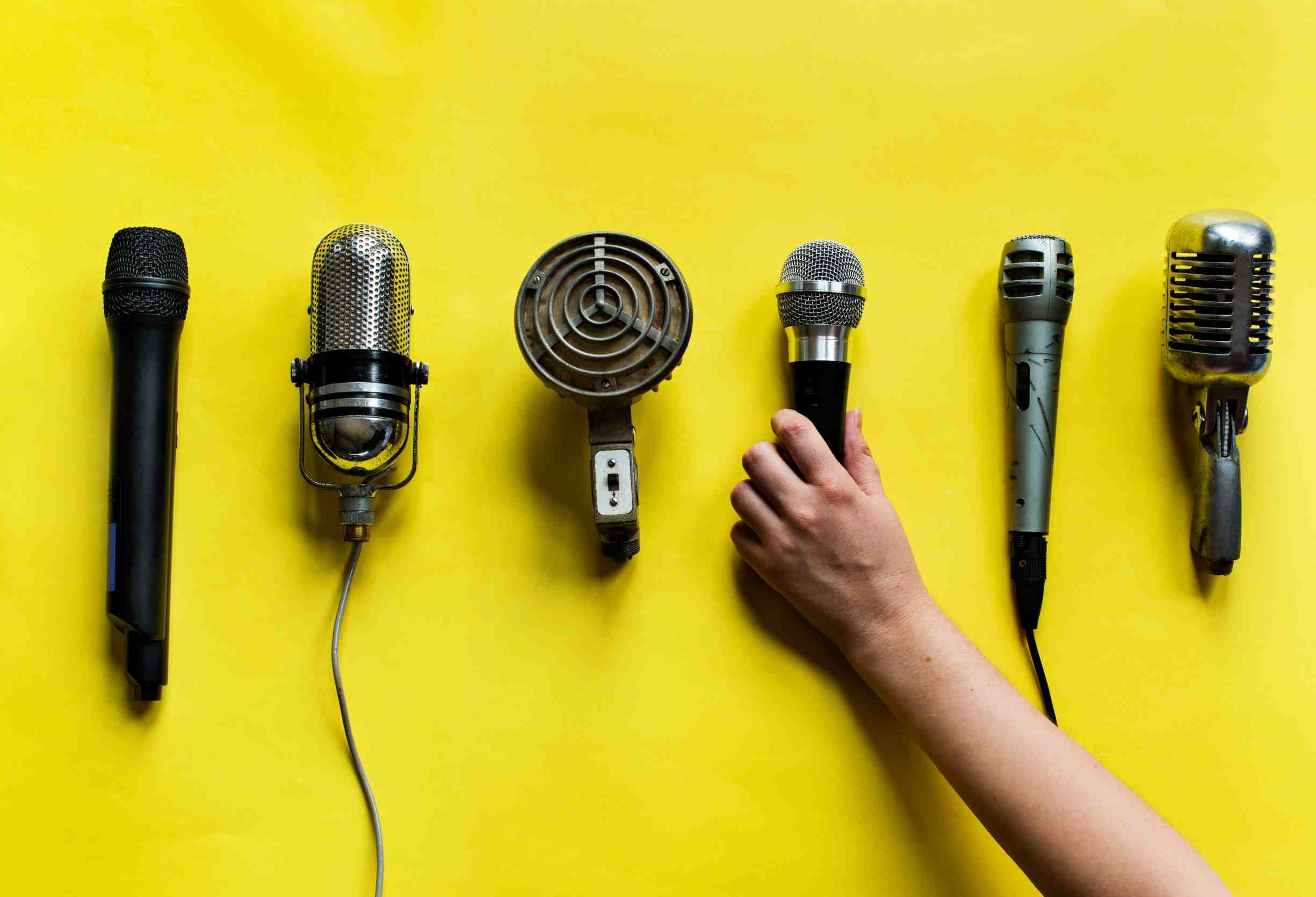 A hand holding a microphone - nonprofit communications