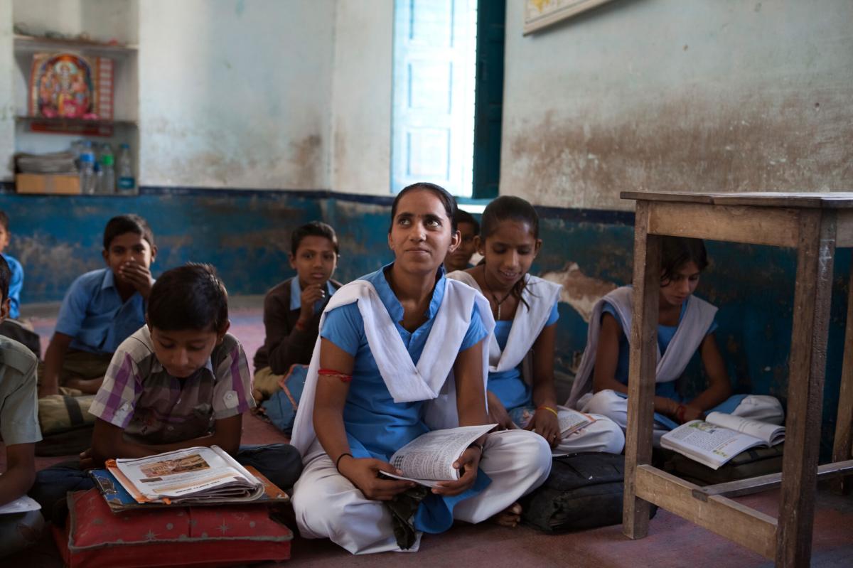 students sitting on a floor in a classroom_youth