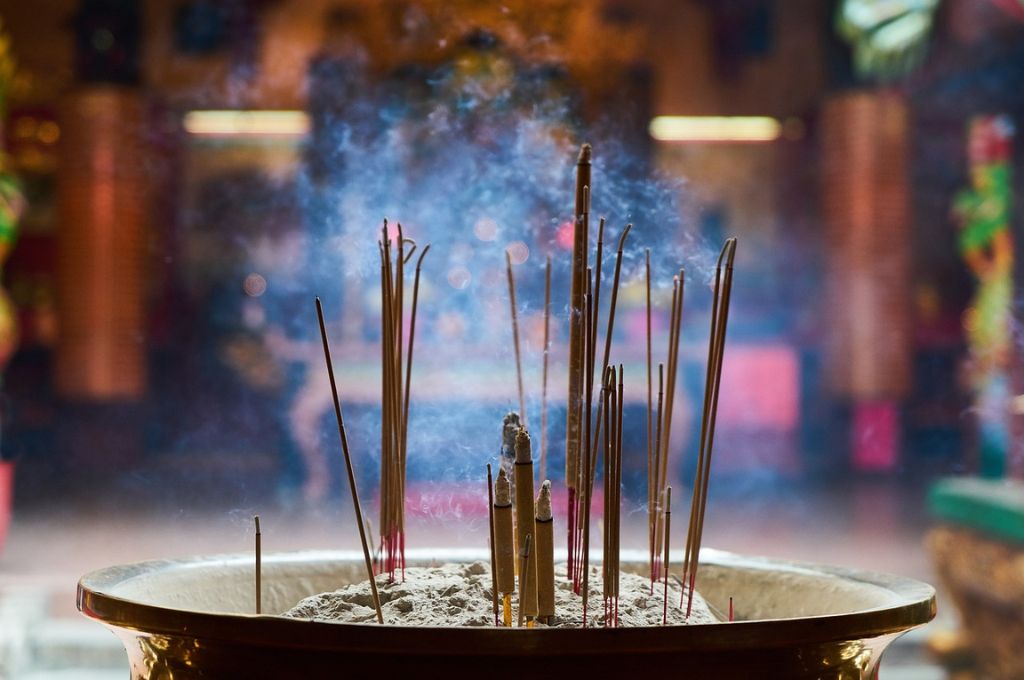 incense sticks burning in a plate_rituals
