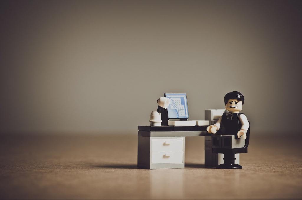 A despaired looking lego man in an office-nonprofit humour
