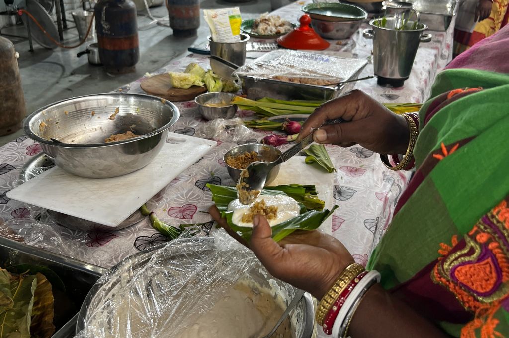 A woman making food in a community kitchen-zero-waste cooking