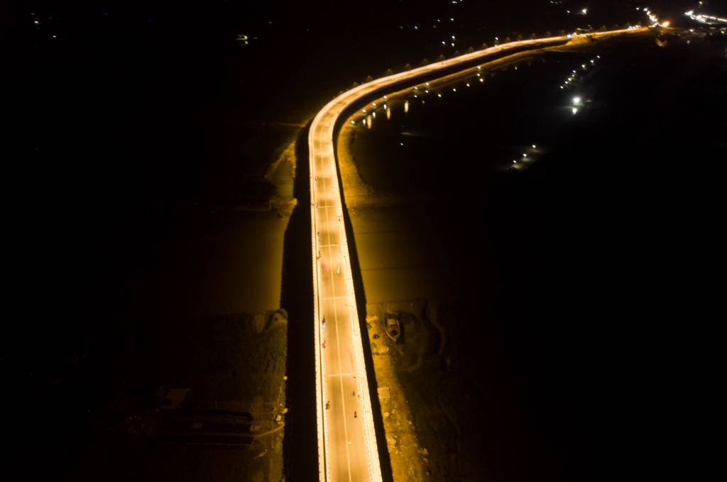 Brightly lit bridge at night_livelihood of fishing community