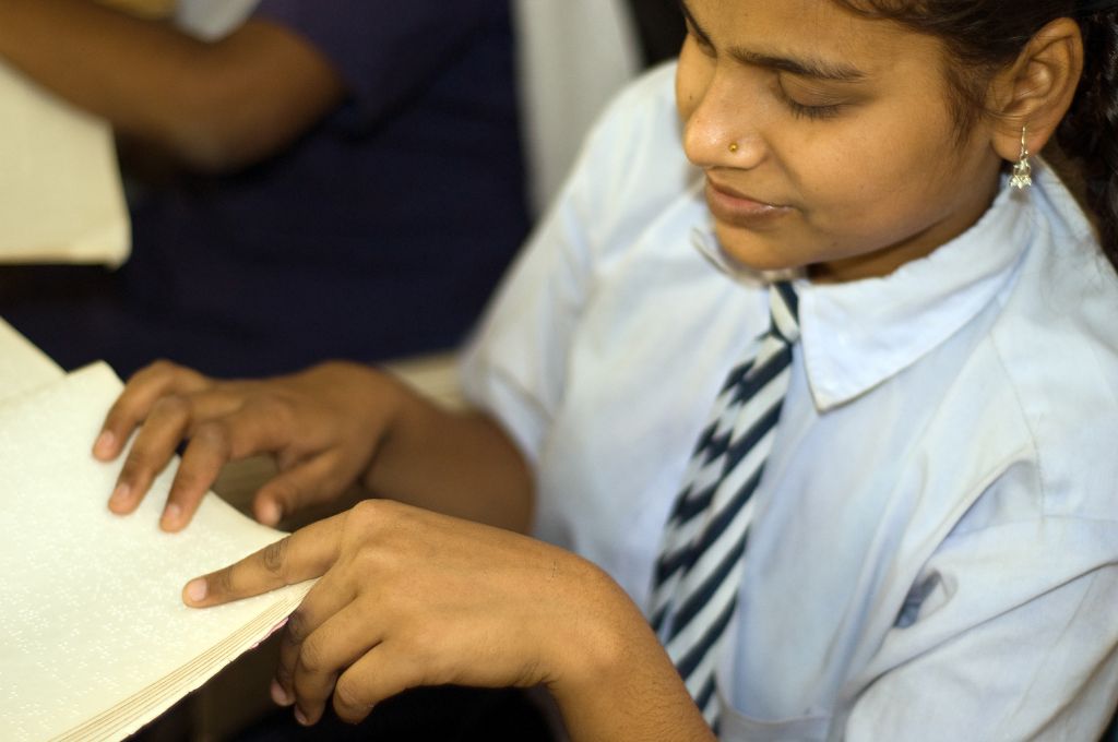 blind girl student reading braille-disability