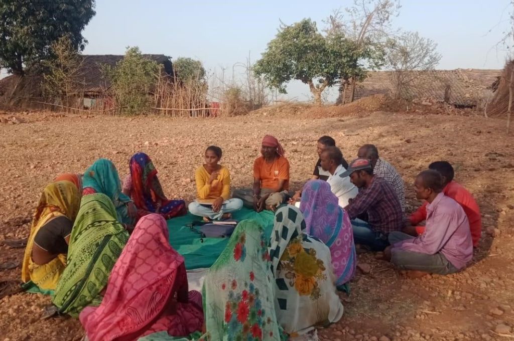 Men and women sitting on a field in a circle_forest resources