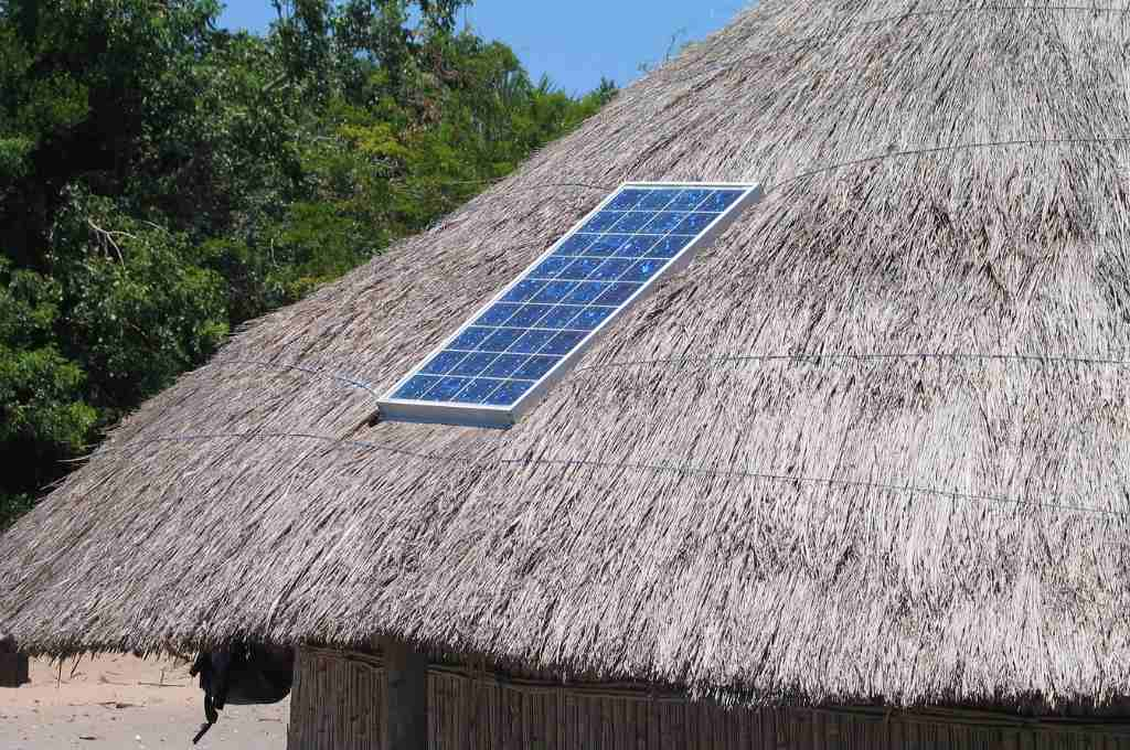 Solar panel on a straw hut_renewable energy sector