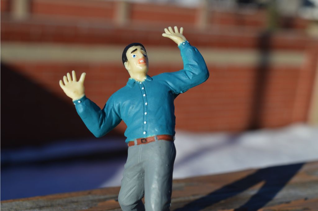 Figurine of a man with hands raised_nonprofit humour