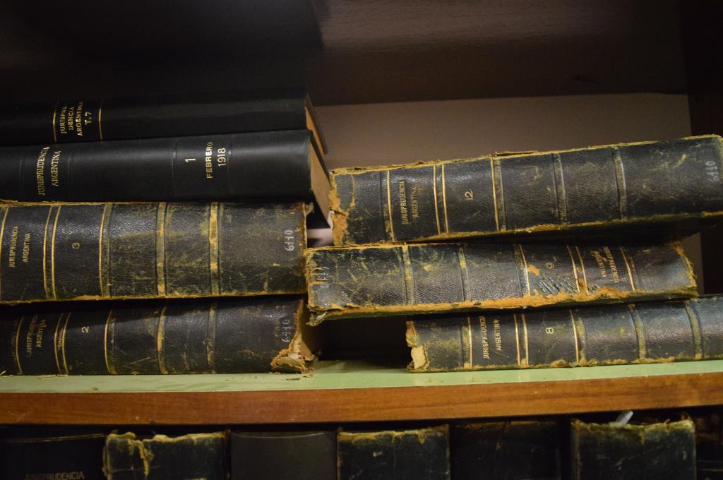 two stacks of old, tattered bound books--sexual harassment