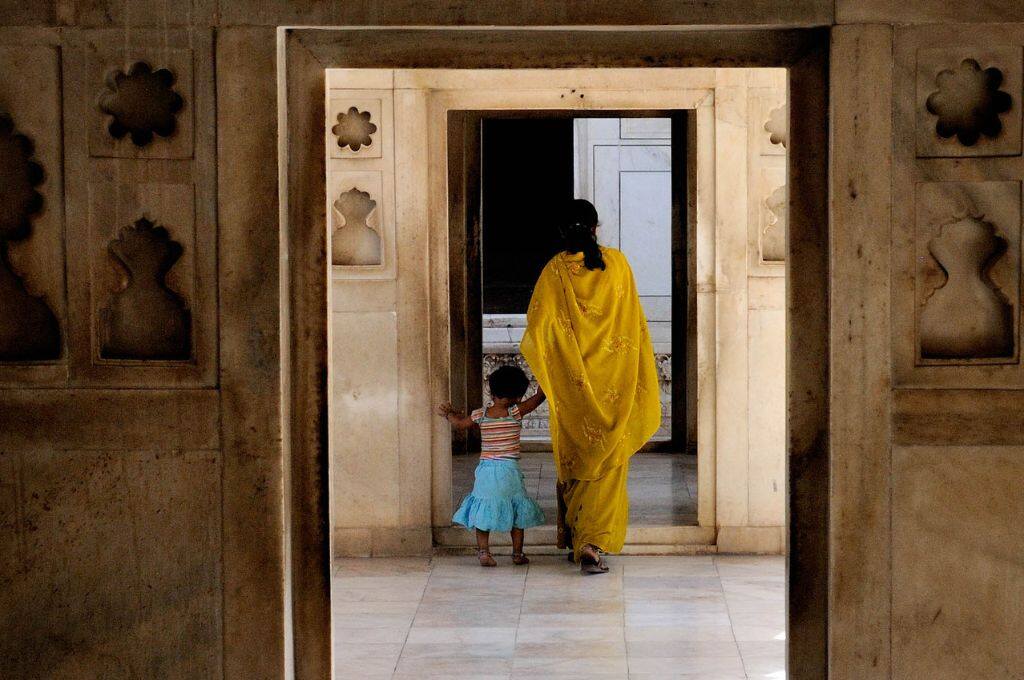 A woman and a child standing in a door_child sexual abuse