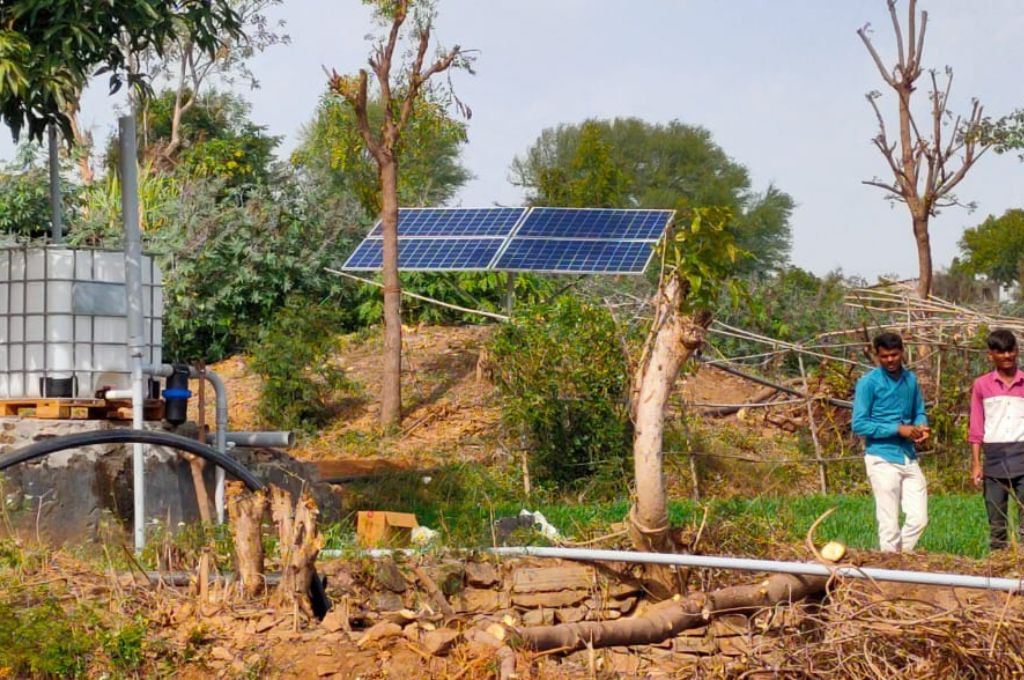 A water tank and solar panel in the field_solar pumps